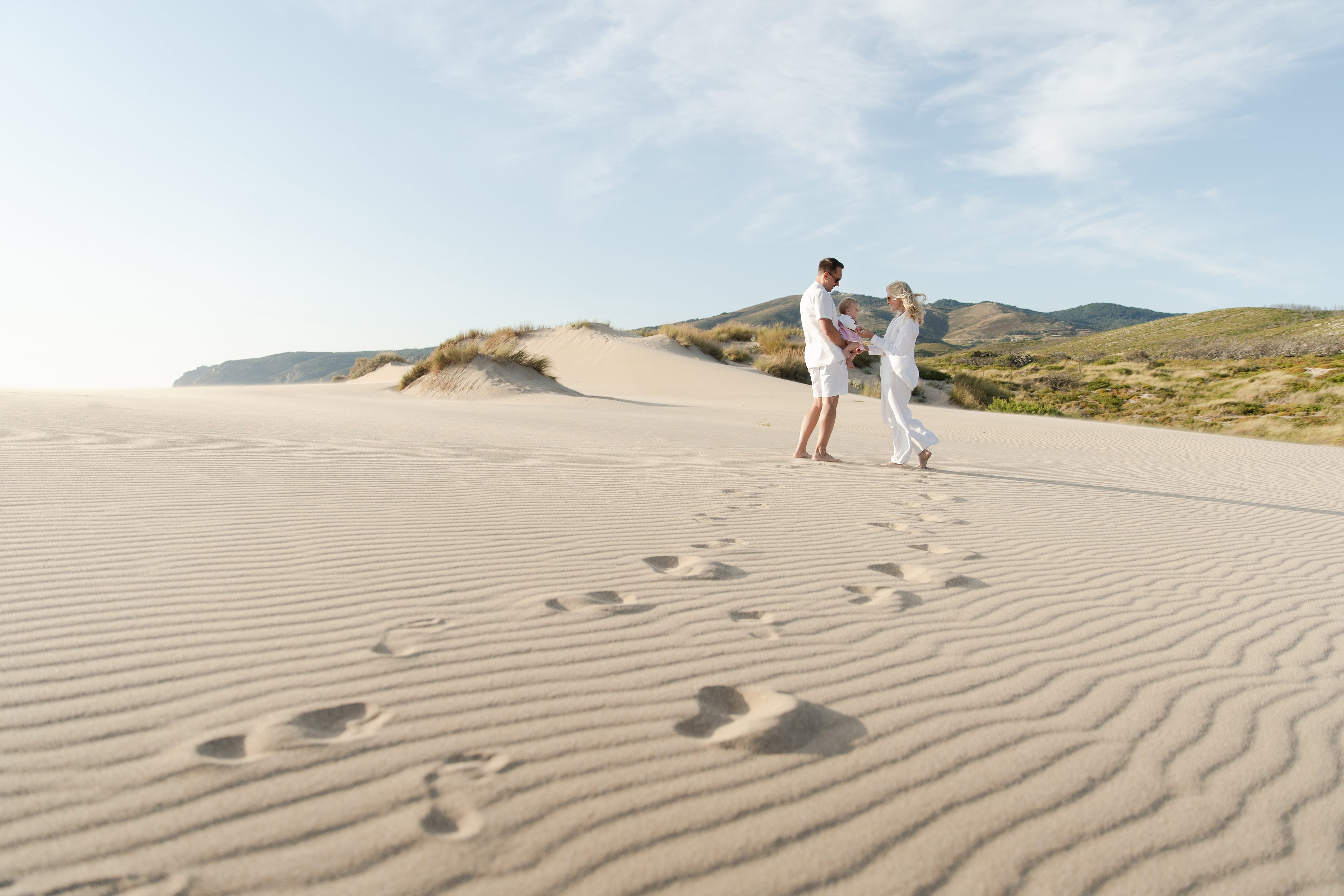Family walking across the dunes at Guincho, Portugal