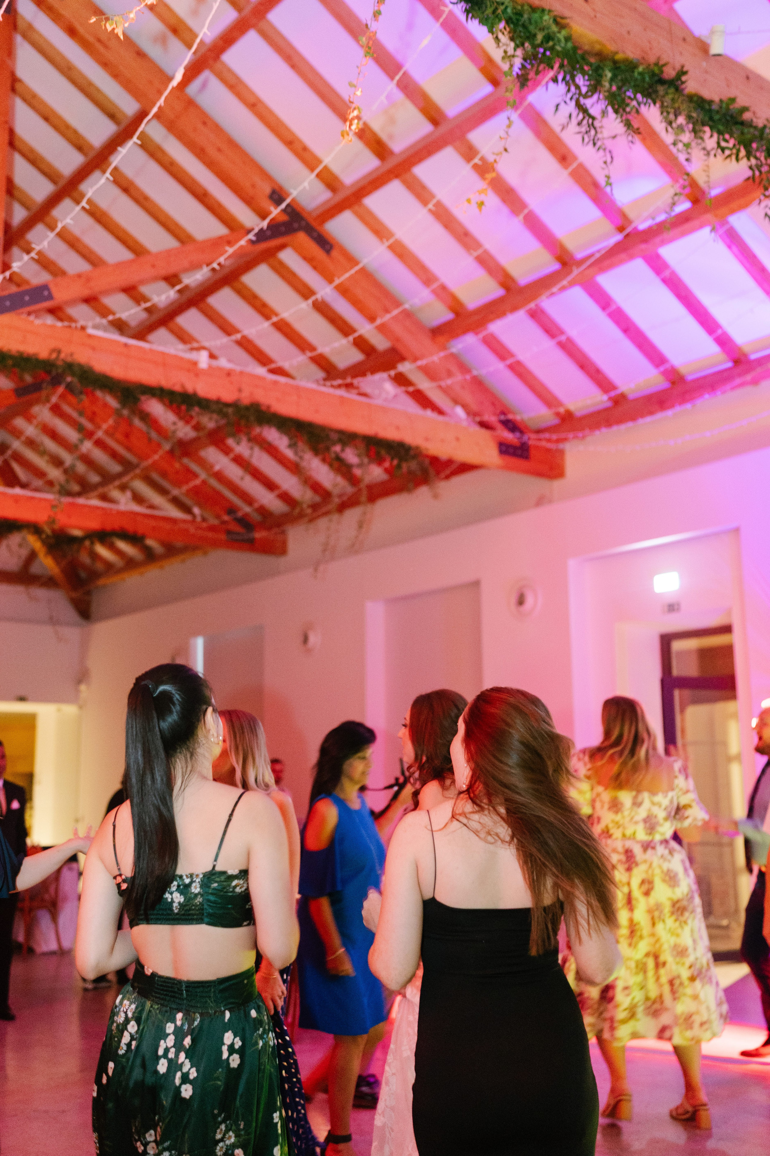 Wedding guests dancing under the timber roof of the reception hall at Quinta do Gradil, Portugal Wedding guests dancing under the timber roof of the reception hall at Quinta do Gradil, Portugal
