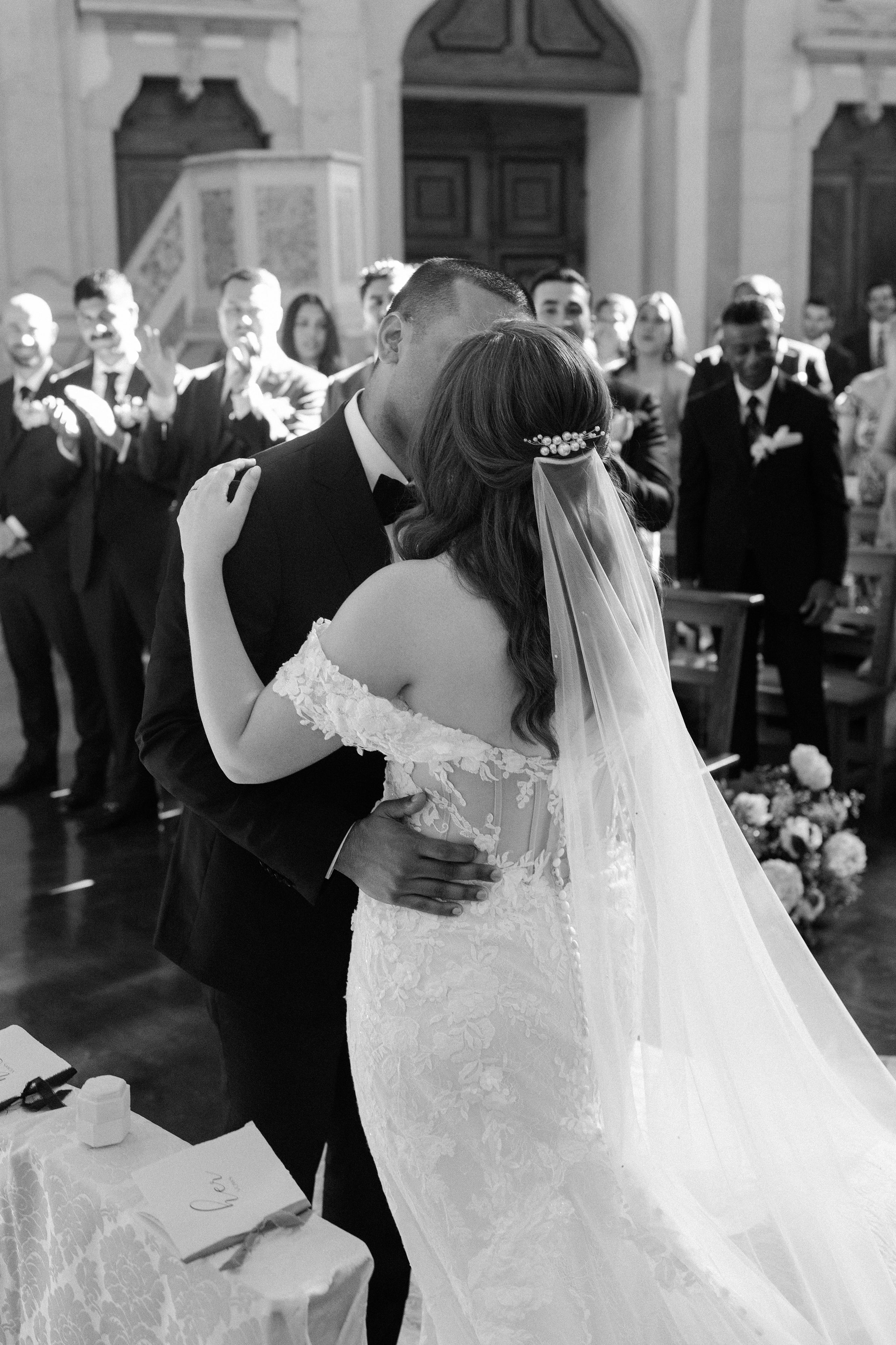 Bride and groom kissing during a church ceremony in Óbidos, Portugal, in autumn Bride and groom kissing during a church ceremony in Óbidos, Portugal, in autumn