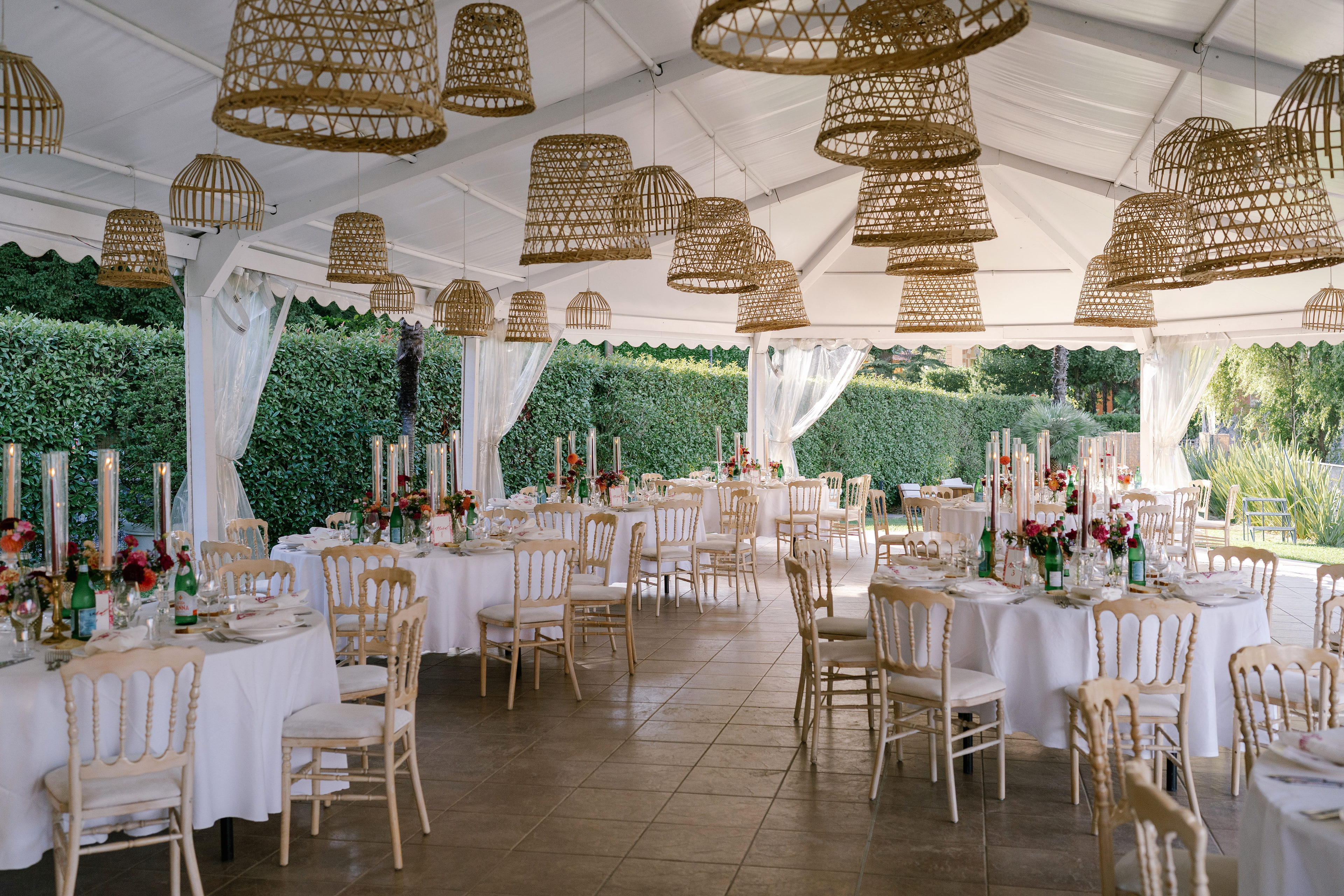 Wedding marquee with wicker lamps and set tables at Lido di Lenno, Lake Como