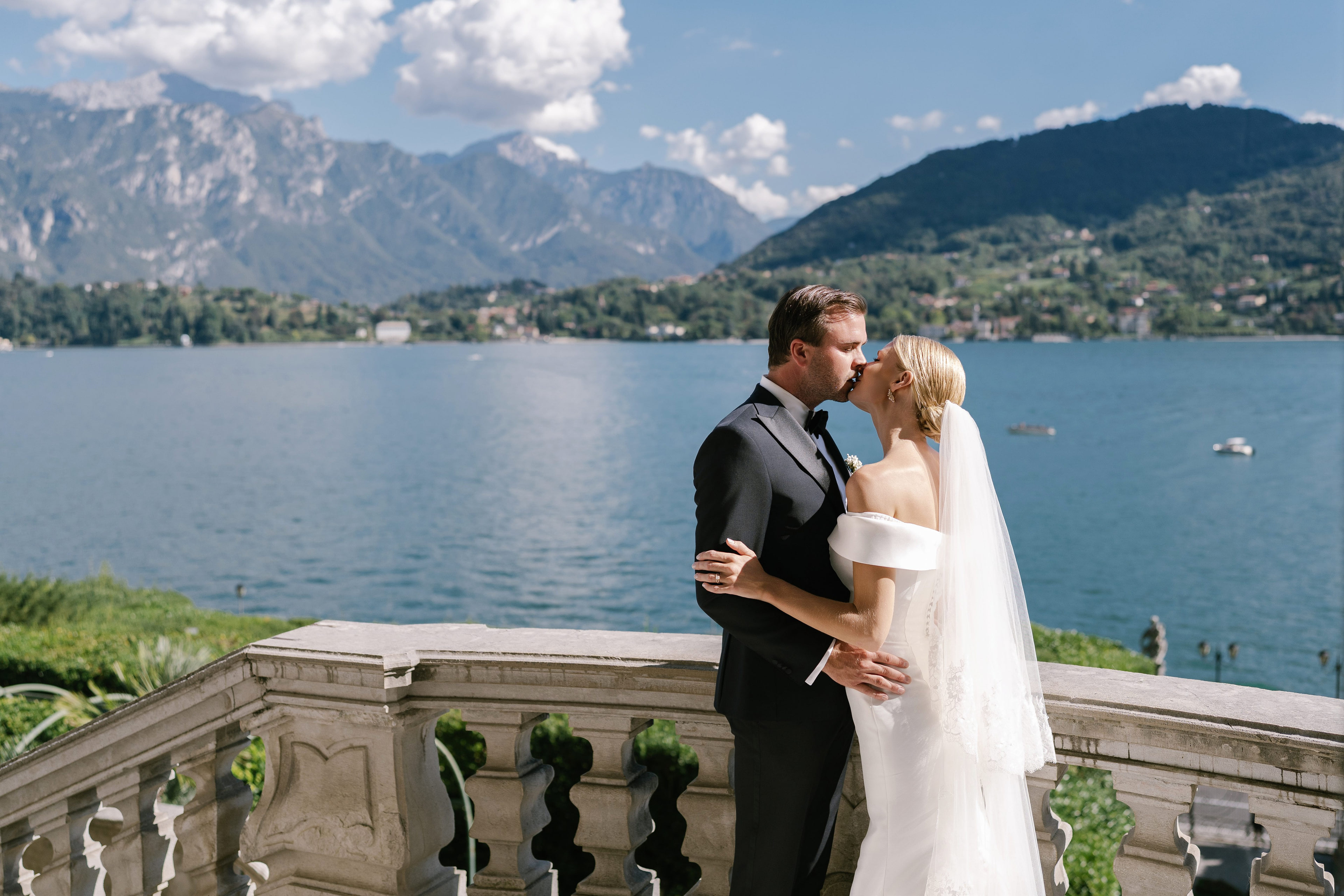 Bride and groom kissing on the terrace of Villa Carlotta above Lake Como, Italy