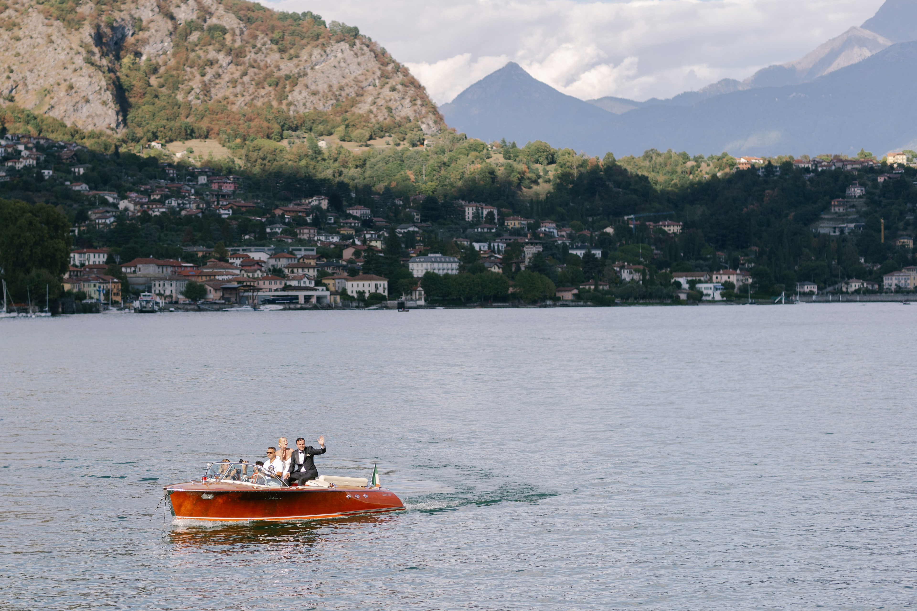 Bride and groom on a wooden speedboat on Lake Como, Italy