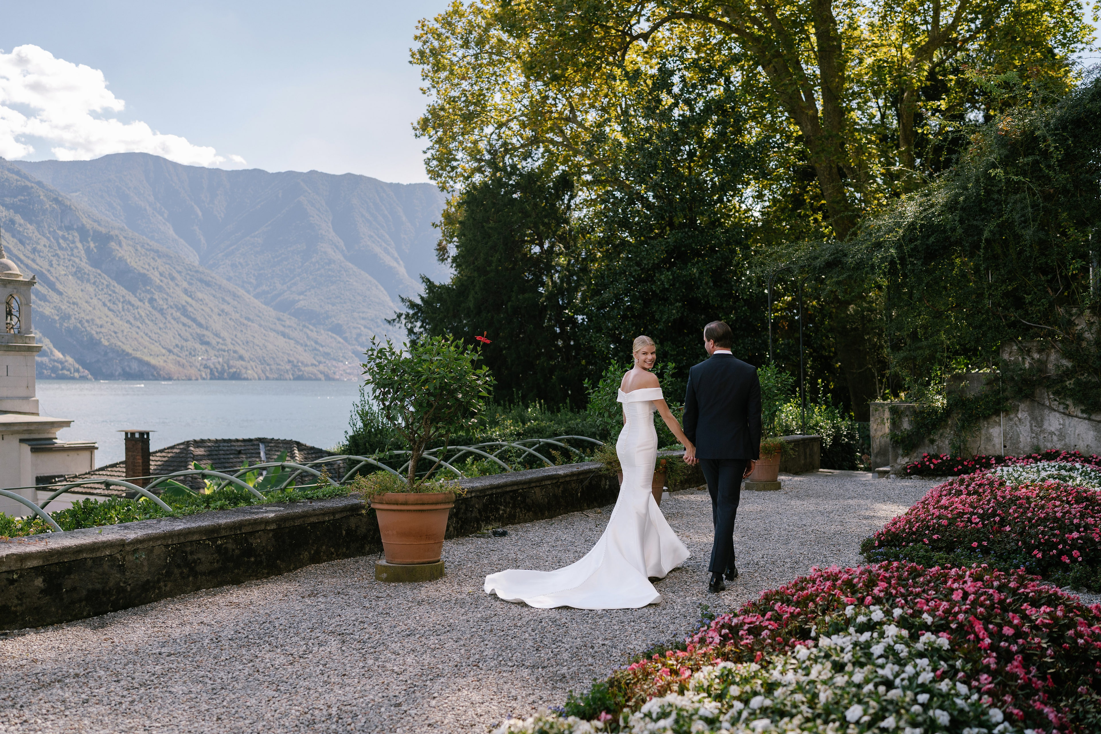 Bride and groom walking through the gardens of Villa Carlotta, Lake Como