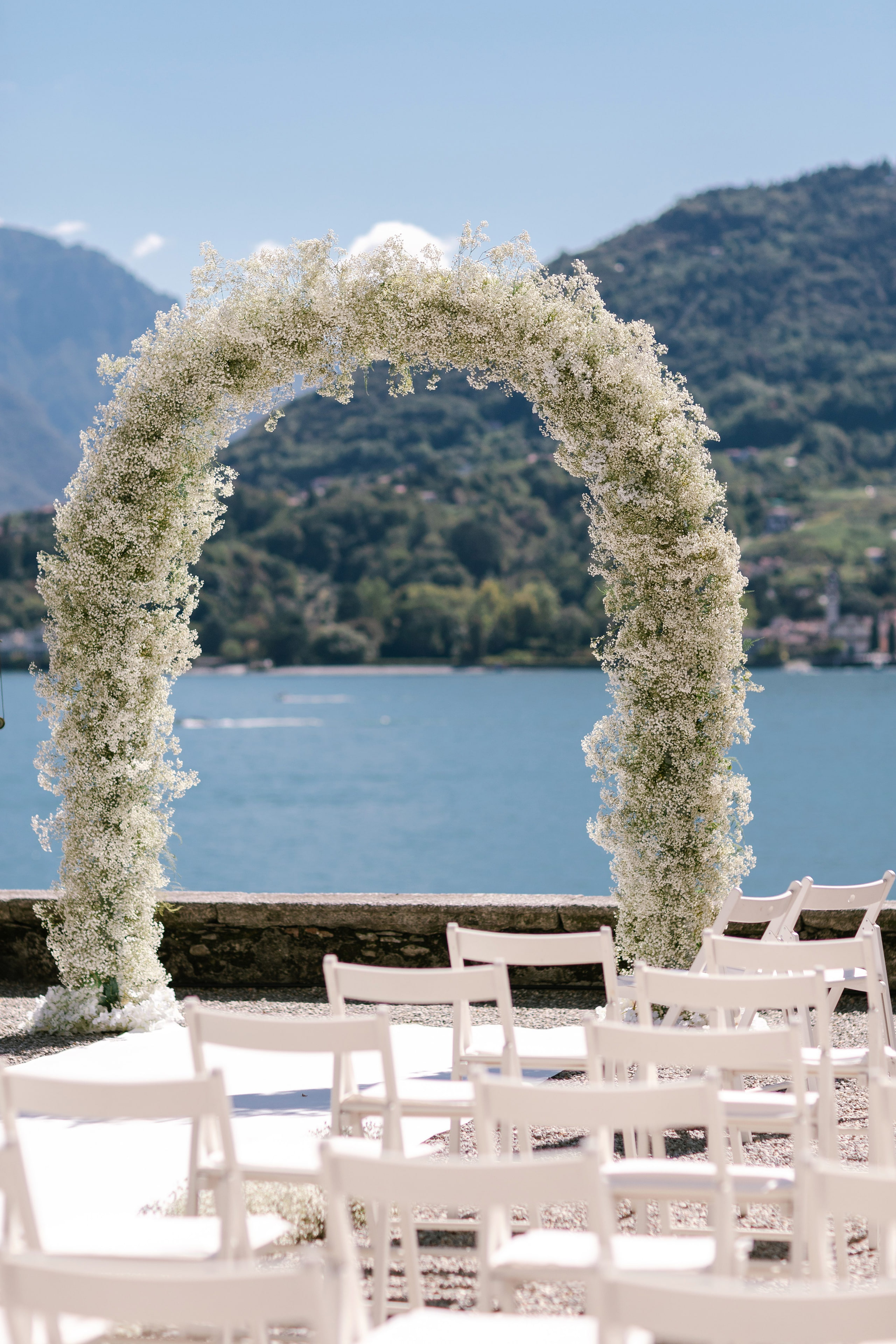 Ceremony arch of white flowers above Lake Como at Villa Carlotta