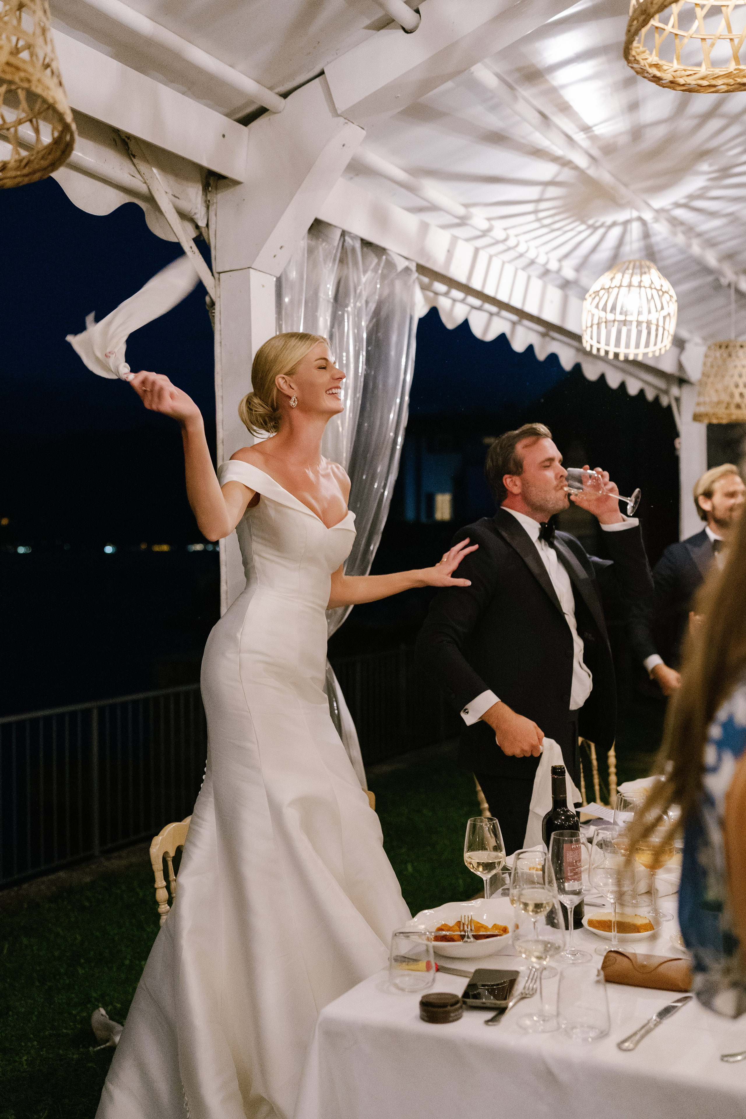 Bride and groom celebrating with their guests under the marquee at Lido di Lenno