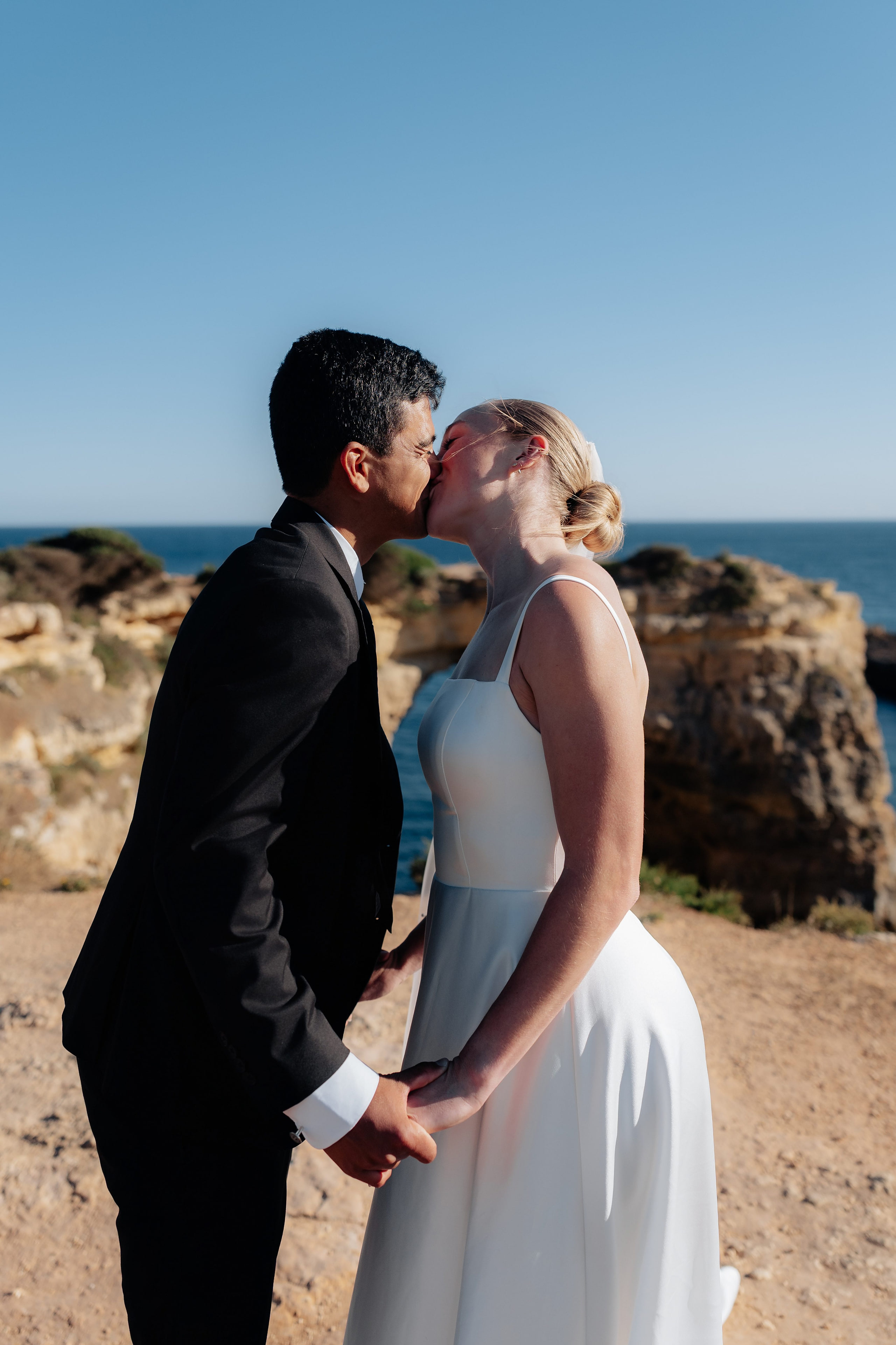 Couple kissing on the golden cliffs above the sea, Algarve Couple kissing on the golden cliffs above the sea, Algarve