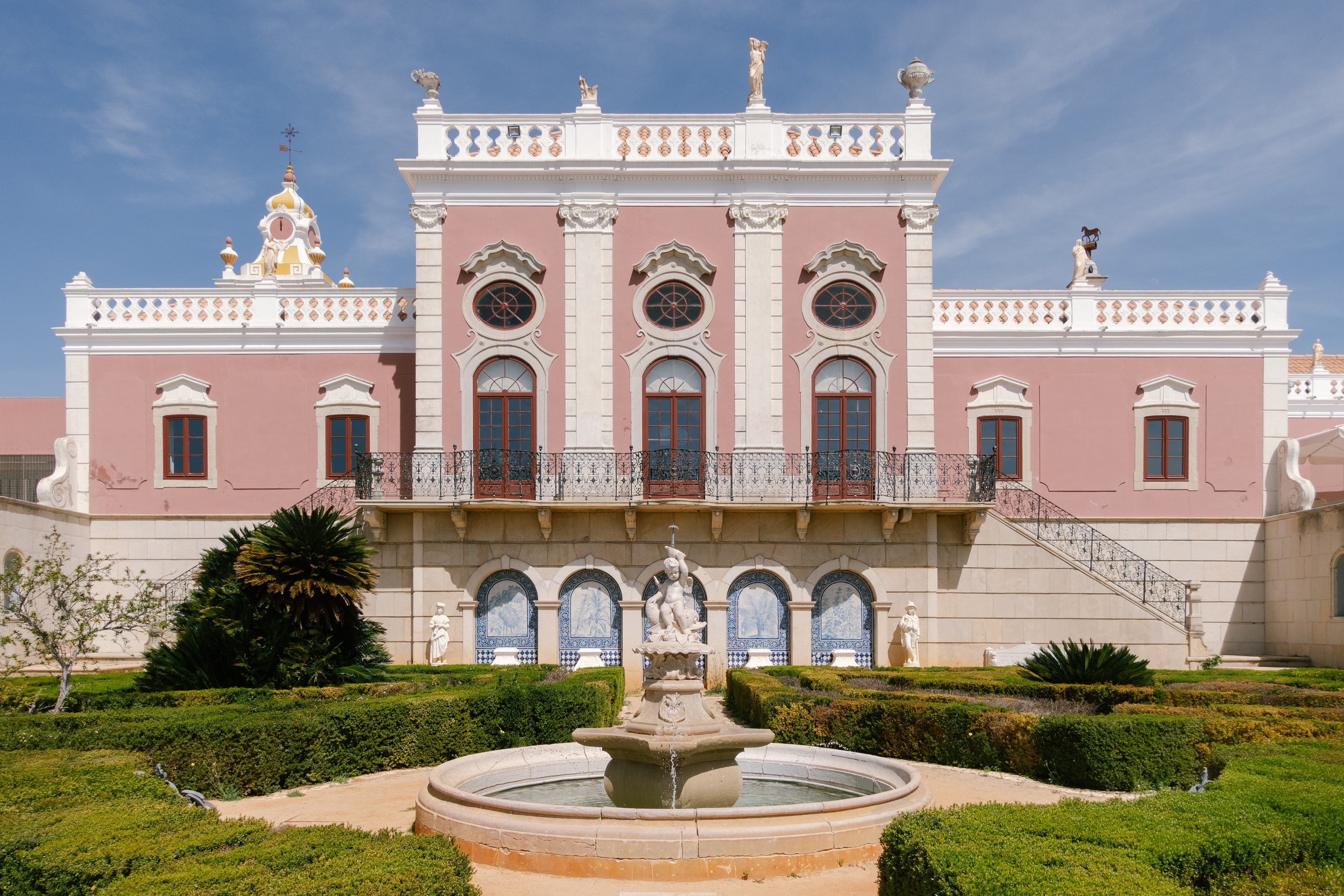 The pink palace of Estoi above its formal garden and fountain, Algarve The pink palace of Estoi above its formal garden and fountain, Algarve