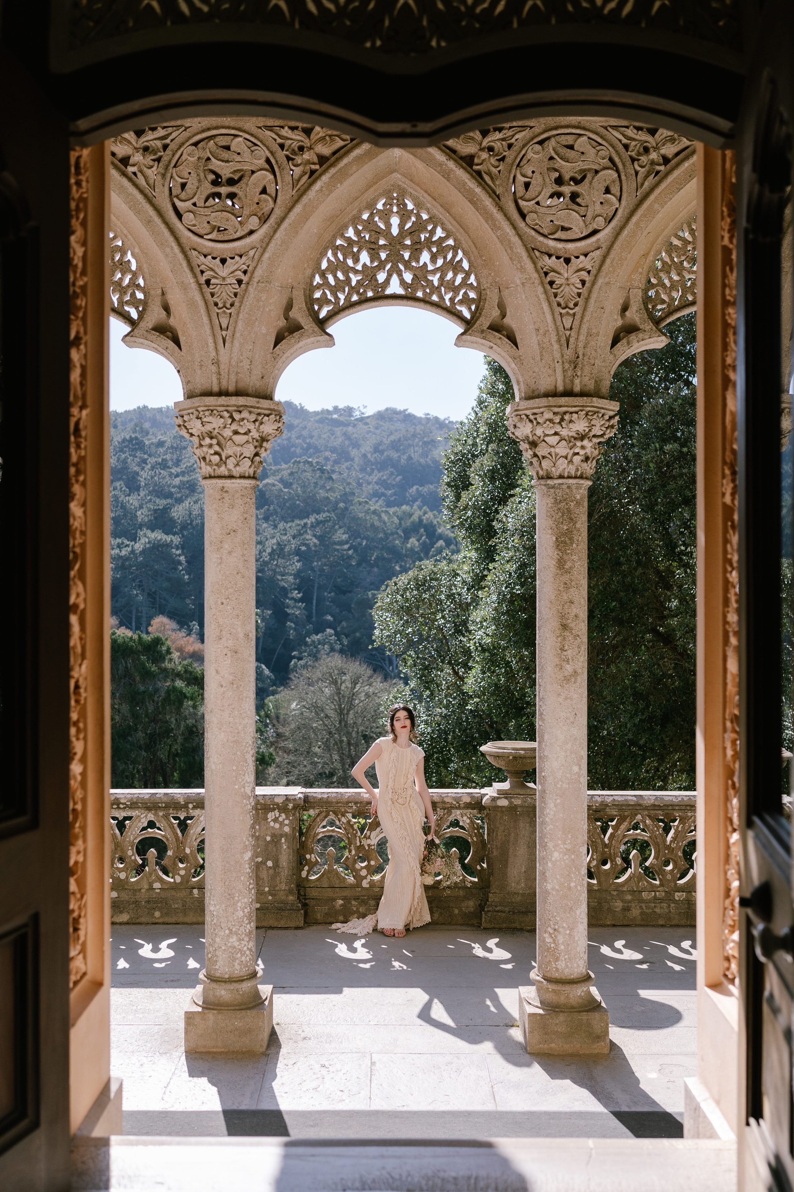 Bride standing under the carved arches of Monserrate Palace, Sintra