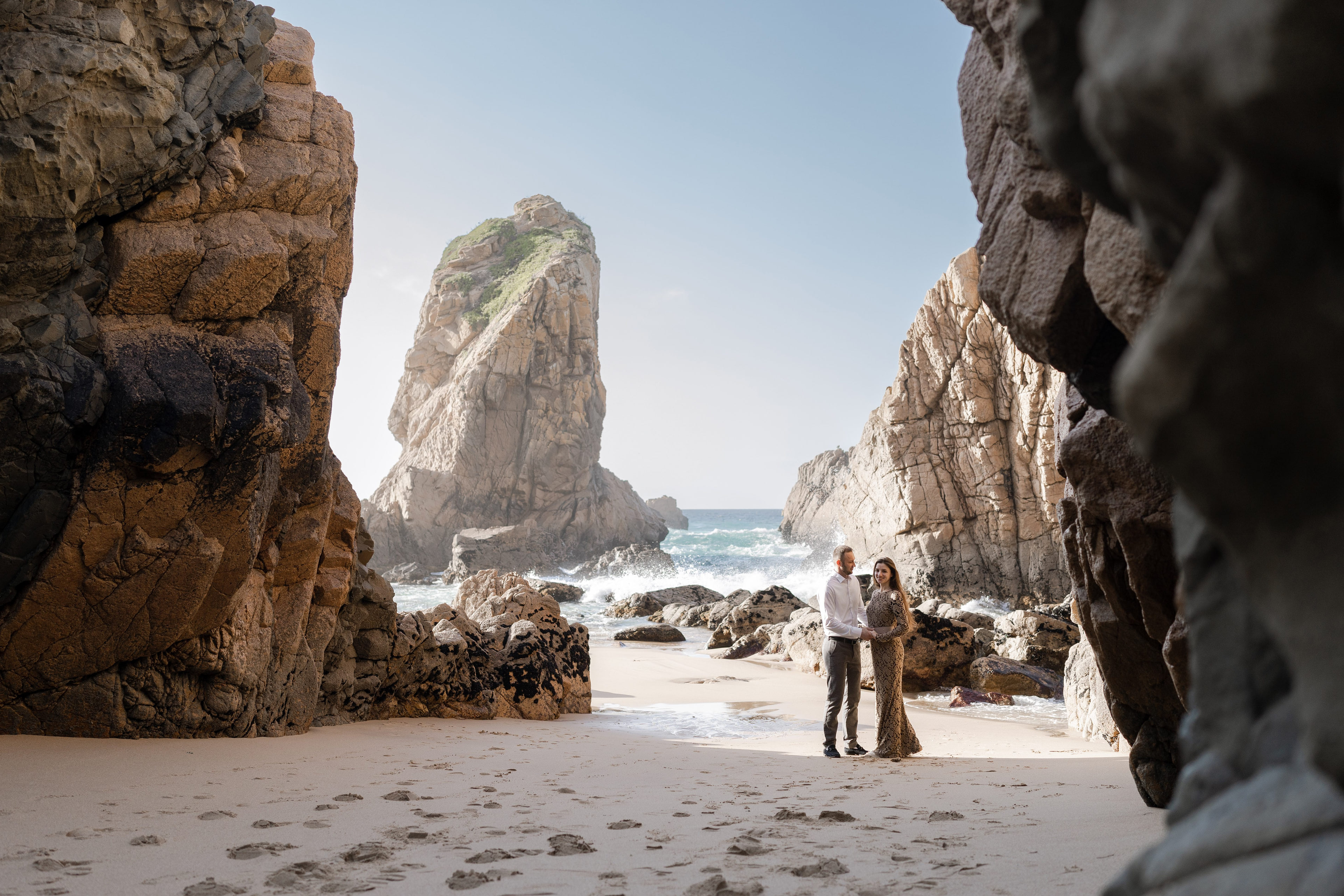 Couple between the cliffs of Praia da Ursa on the Sintra coast, Portugal