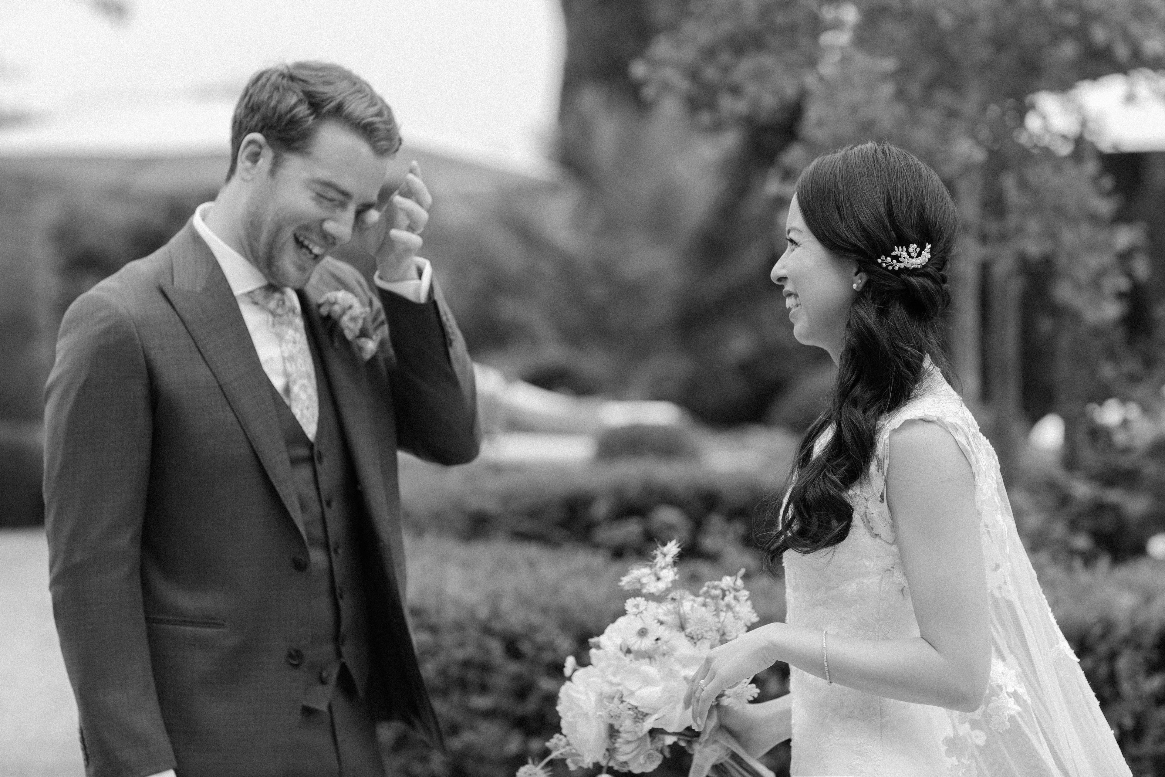 Emotional groom wiping a tear during a classic First Look with his bride at their wedding. Emotional groom wiping a tear during a classic First Look with his bride at their wedding.